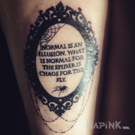 Tattoo Iluzja i chaos in lettering motif on the forearm