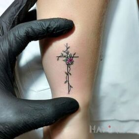 Tattoo Small cross on the forearm motif: flowers
