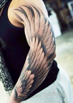 Tattoo Kawał skrzydła in sleeves motif and realistic style on the upper arm