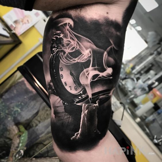Tattoo Zadymiony czas in 3D motif and realistic style on the upper arm