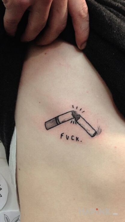 Tattoo FUCK in lettering motif on the ribs