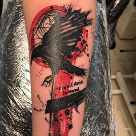 Tattoo Raven trash polka on the forearm motif: lettering style: trash polka