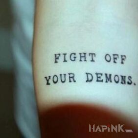 Tattoo Fighting demons on the forearm motif: lettering