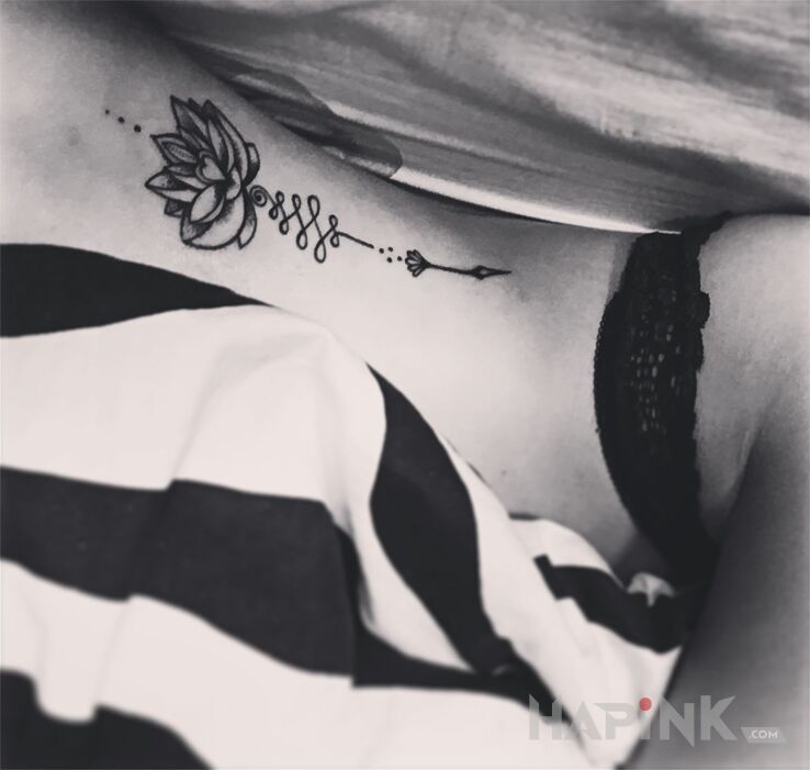 Tattoo Pierwszy ,ale nie ostatni :) in flowers motif on the ribs