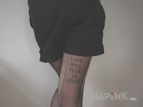 Tattoo Miłość in lettering motif on the leg