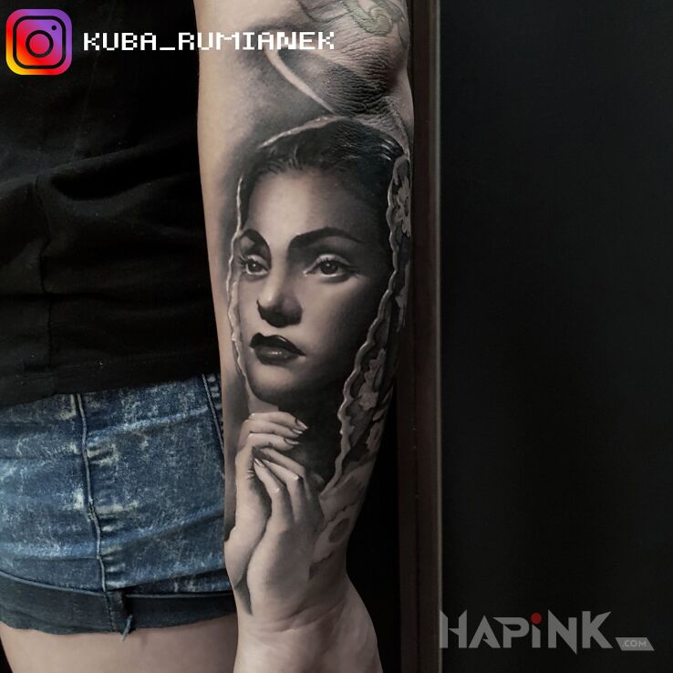 Tattoo Maryja in religious motif and realistic style on the forearm