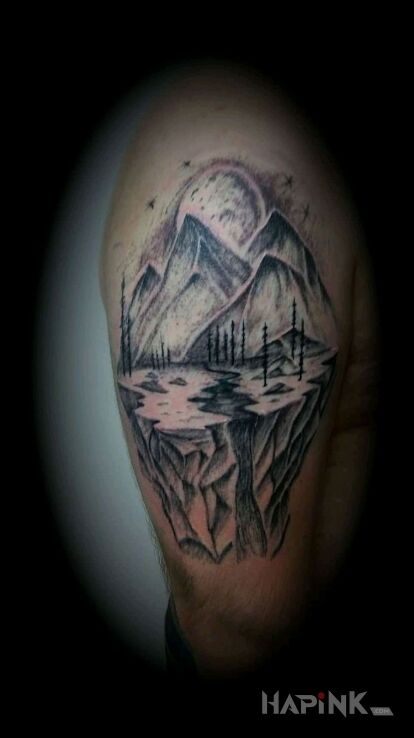 Tattoo Góry in black and gray motif and graphic / illustrative style on the upper arm