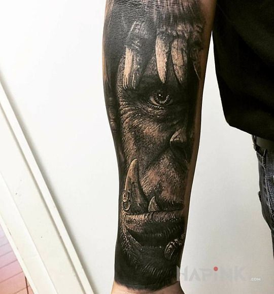 Tattoo Warcraft in faces motif on the forearm