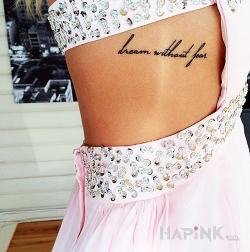 Tattoo Nauka in lettering motif on the ribs