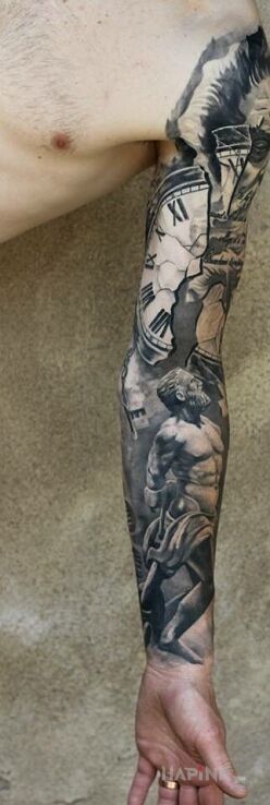 Tattoo Rozpad czasu in sleeves motif and realistic style on the upper arm
