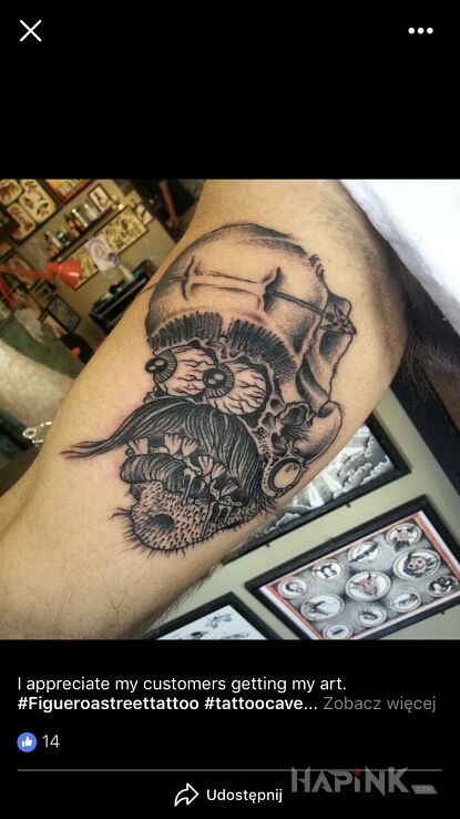 Tattoo Sztos in faces motif on the upper arm