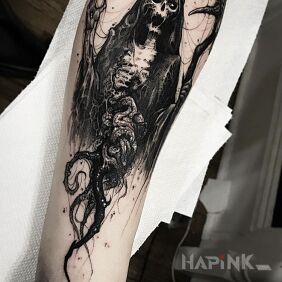 Tattoo Demonic figure on the forearm motif: skulls