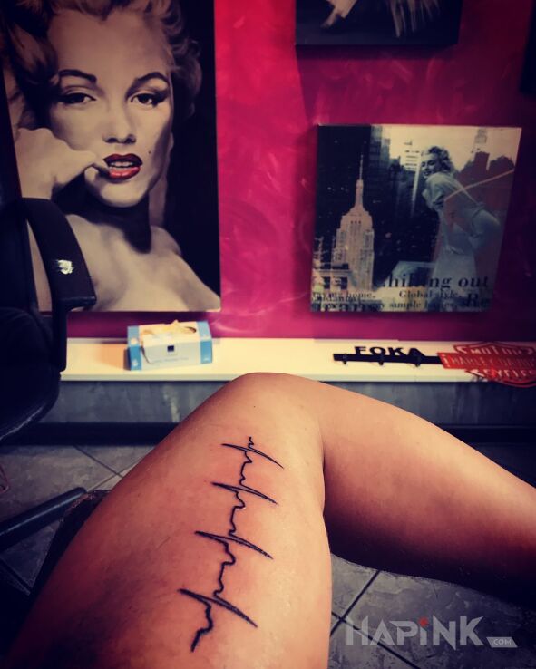 Tattoo EKG  bicie serca in other motif on the upper arm