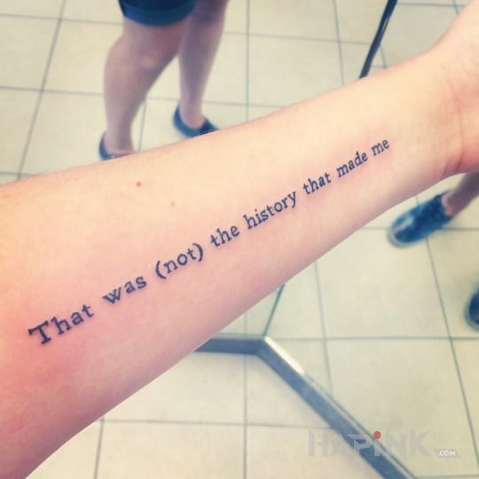 Tattoo Pewna historia in lettering motif on the forearm
