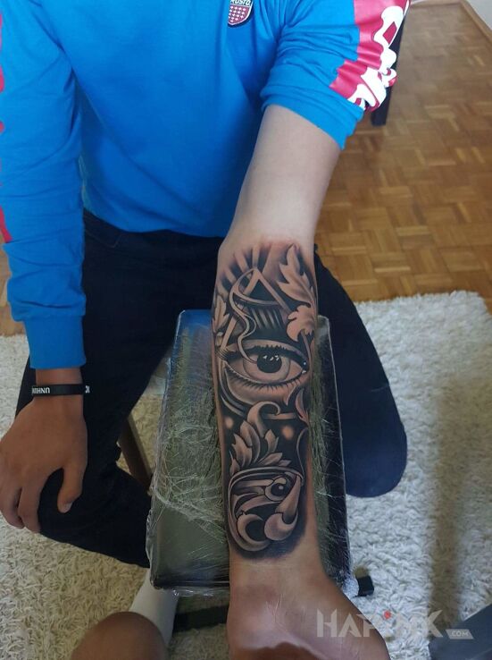 Tattoo Iluminati in other motif on the forearm