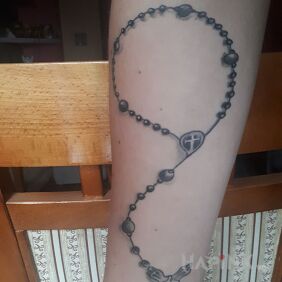 Tattoo Rosary on the forearm motif: religious