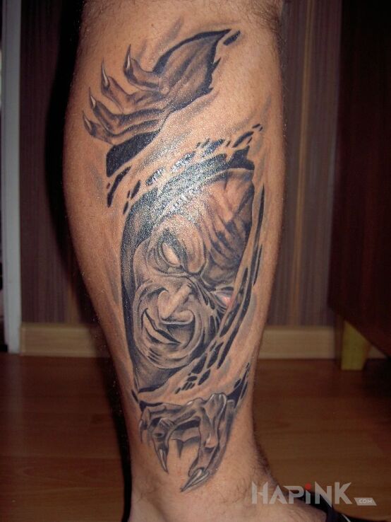 Tattoo DEMON in faces motif on the calf