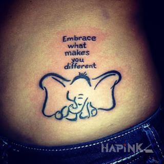 Tattoo Bycie innym in lettering motif on the ribs