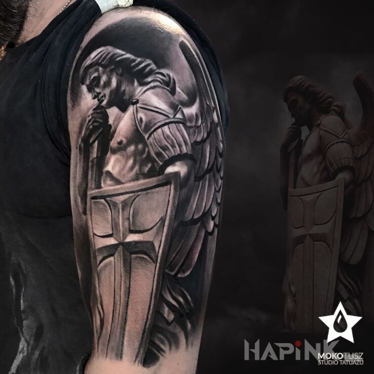 Tattoo Święty Michał Archanioł in religious motif and realistic style on the upper arm