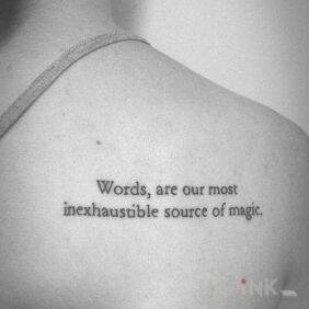 Tattoo Magic words on the shoulder blades motif: lettering