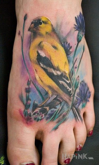 Tattoo Ptaszyna in colorful motif and realistic style on the foot