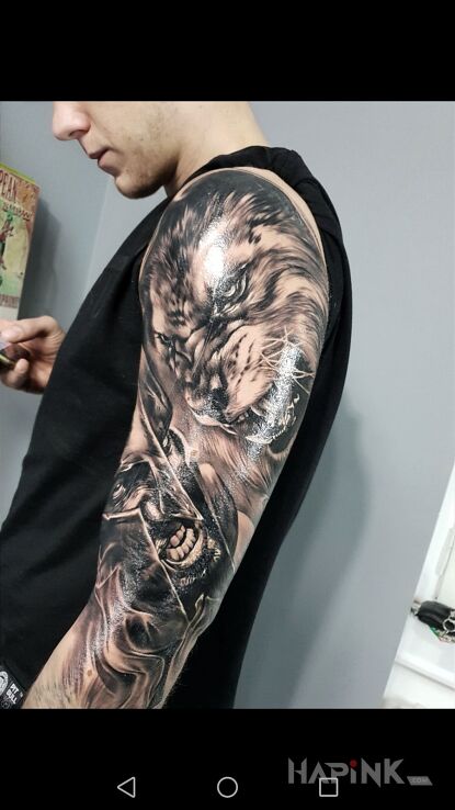 Tattoo #Spartan #Lion #Tattoo in characters motif and realistic style on the upper arm