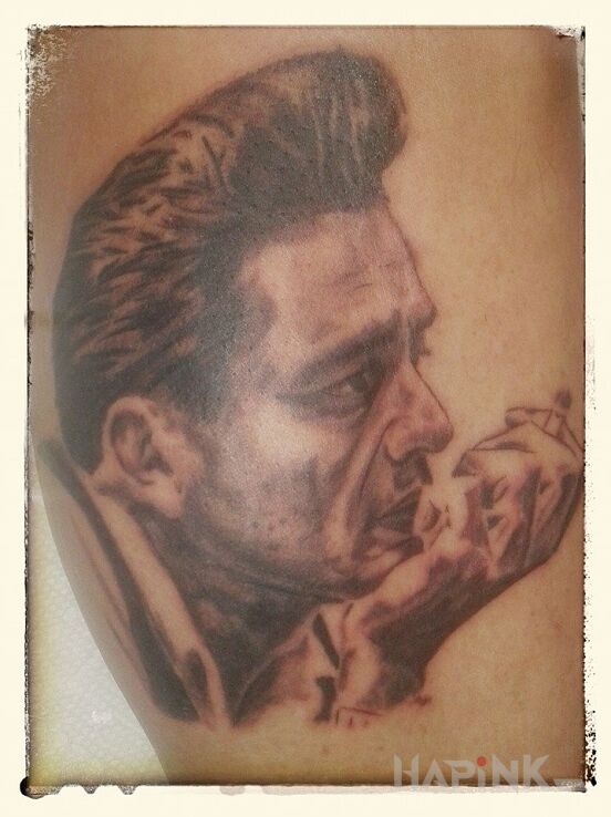 Tattoo Jhonny cash in faces motif on the upper arm