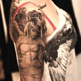 Tattoo Beautiful angel on the upper arm motif: flowers
