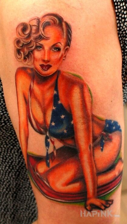 Tattoo Pin up girl 2 in characters motif on the upper arm