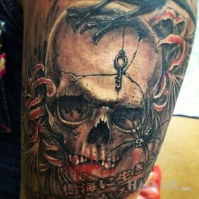 Tattoo Krawa czacha on the upper arm motif: skulls