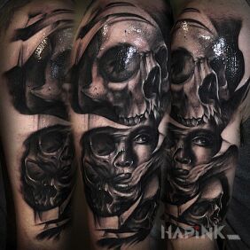Tattoo A woman among skulls on the upper arm motif: skulls