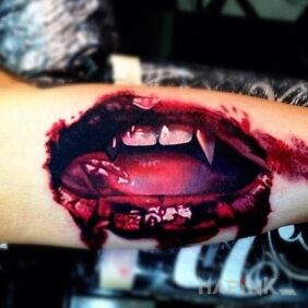 Tattoo Mouth of the vampire on the forearm motif: demons