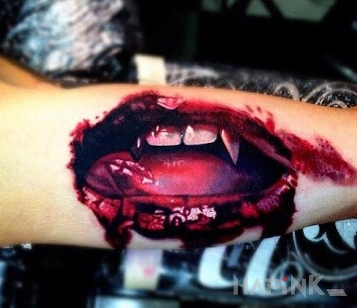 Tattoo Usta wampira in demons motif on the forearm