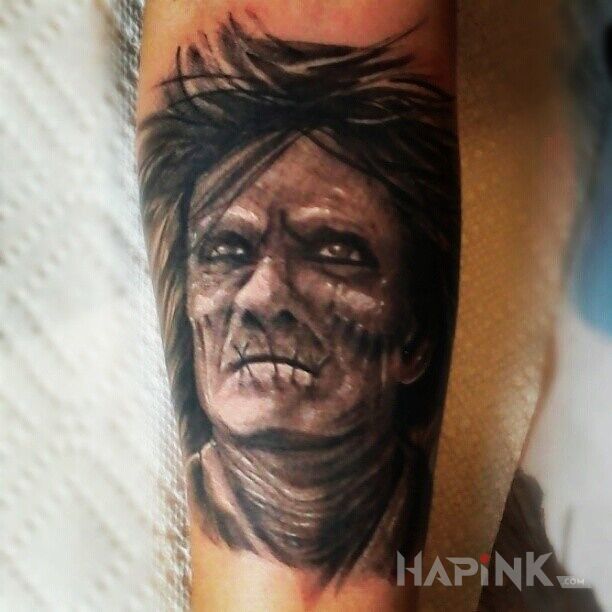 Tattoo Jakiś stwór in faces motif on the forearm