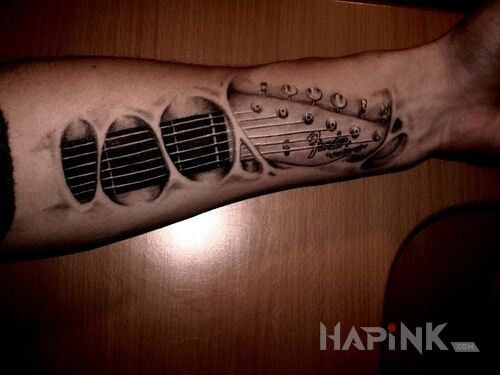 Tattoo Gitara in objects motif on the forearm