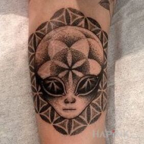 Tattoo A being from another planet on the forearm motif: characters