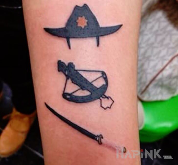 Tattoo The Walking Dead in objects motif on the forearm
