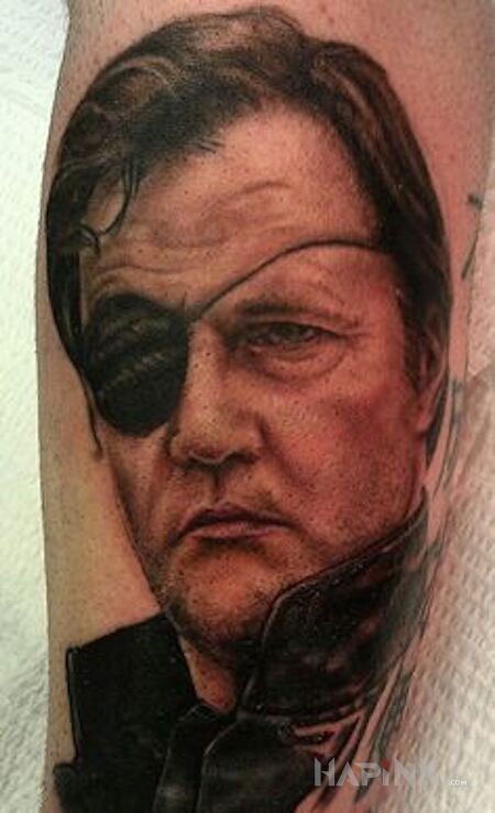 Tattoo Gubernator in faces motif on the forearm