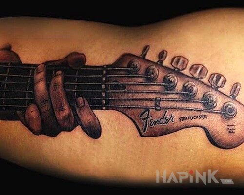 Tattoo Gitara gra in other motif on the upper arm