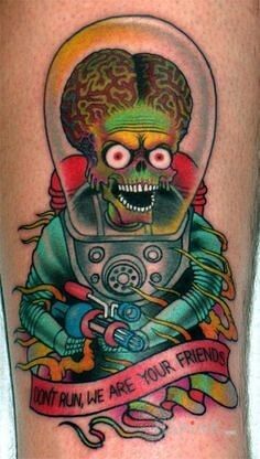 Tattoo Ufo in characters motif on the forearm