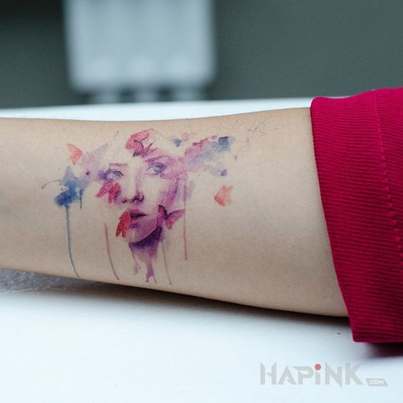 Tattoo Mała twarz in colorful motif and Watercolor style on the forearm