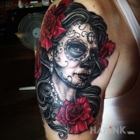 Tattoo Mexican theme on the upper arm motif: flowers