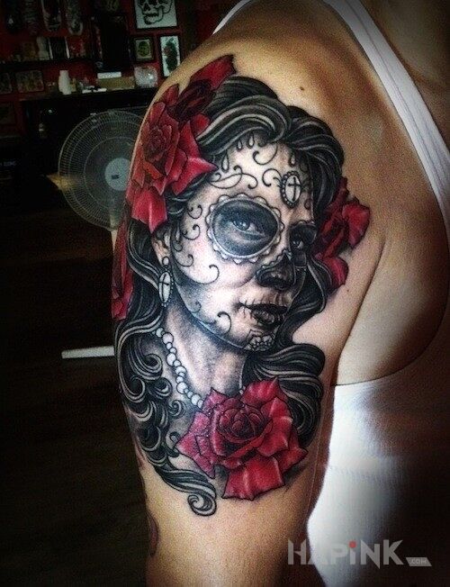 Tattoo Meksykański motyw in faces motif on the upper arm