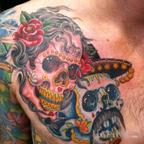 Tattoo Dia de los Muertos on the chest motif: skulls