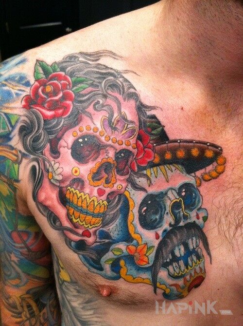Tattoo Dia de los Muertos in skulls motif on the chest