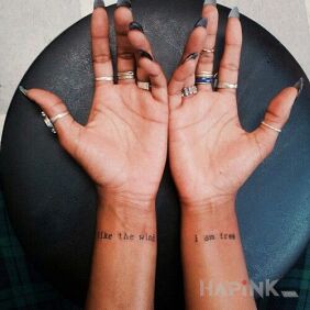 Tattoo Free as the wind on the wrist motif: lettering