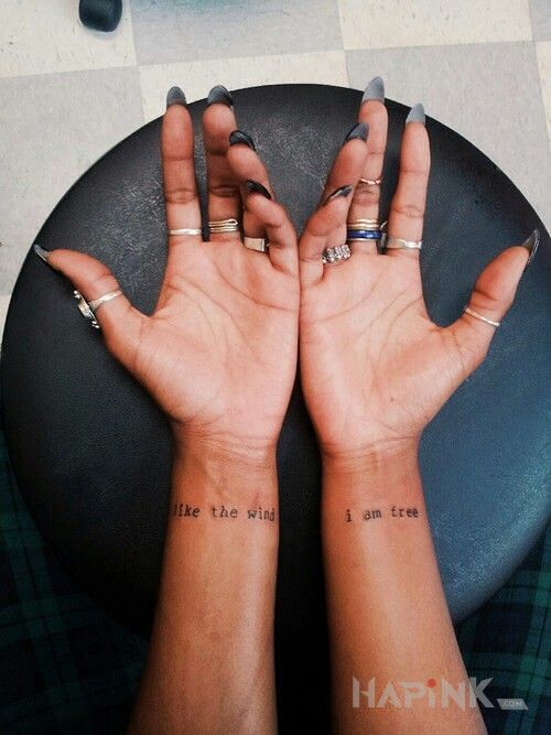 Tattoo Wolna jak wiatr in lettering motif on the wrist