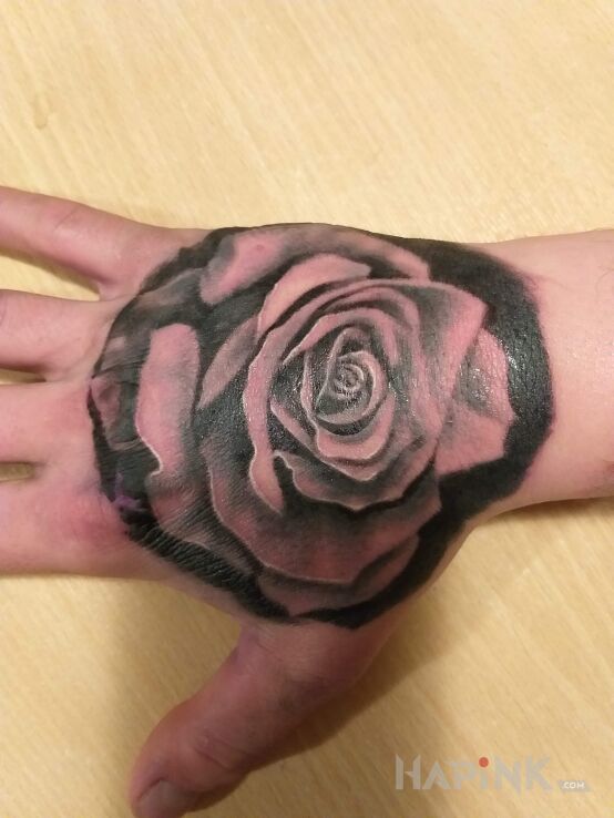 Tattoo Róża ;) in flowers motif on the hand