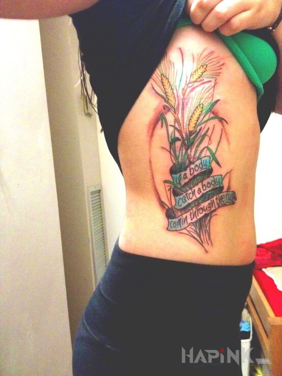Tattoo Napis in colorful motif on the ribs