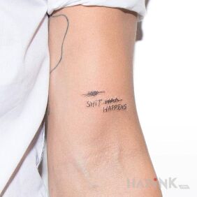 Tattoo Shit happens on the upper arm motif: lettering